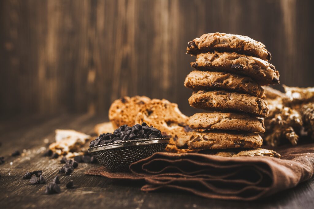 chocolate chip cookies on fabric with wood background